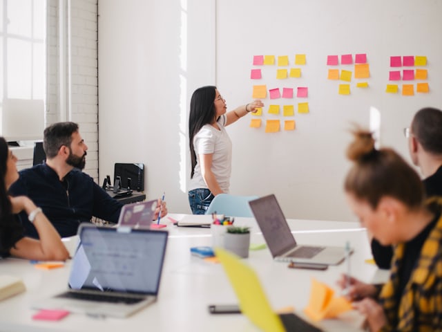 Team discussing content strategy at a sticky-note wall