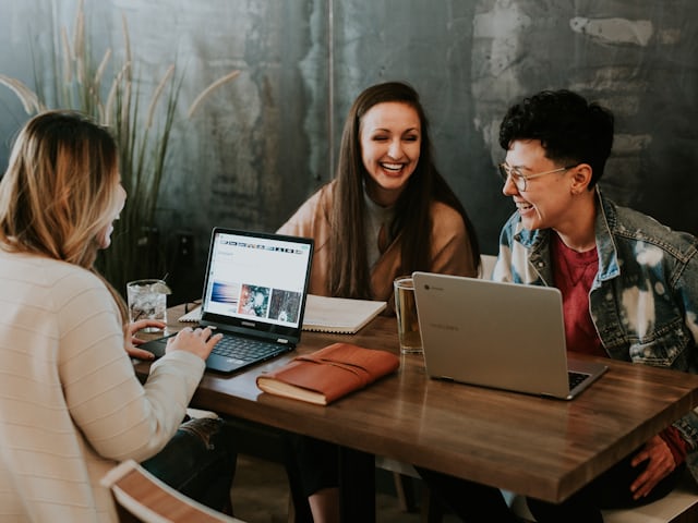 Content team planning articles around a laptop